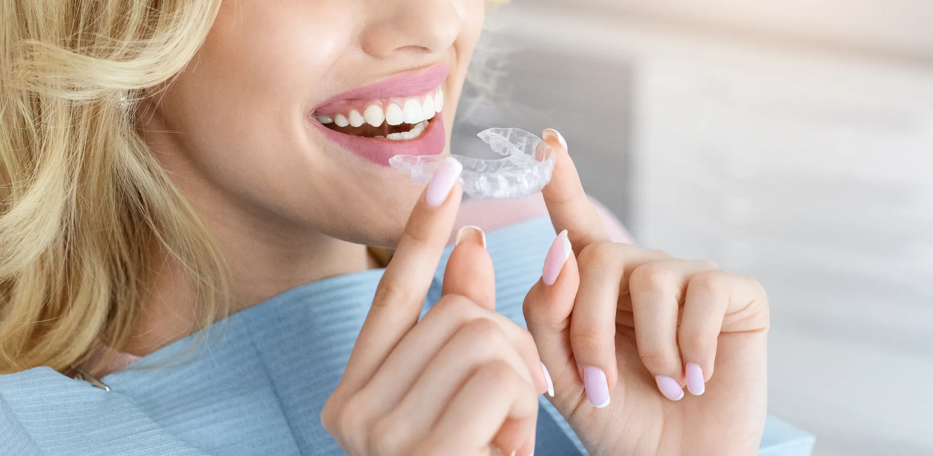Woman smiling with Invisalign aligners